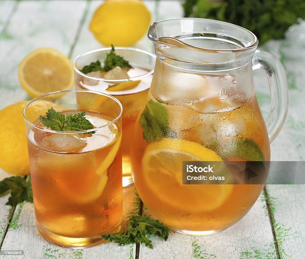 Iced tea Ice tea with mint and lemon on a white table Drinking Glass Stock Photo