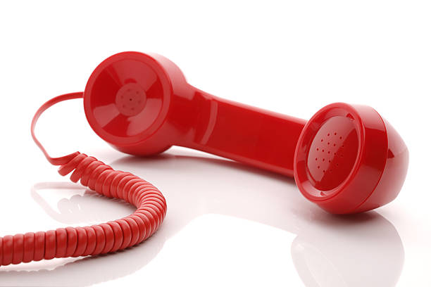 Red telephone receiver Red old fashioned telephone handset isolated on a white concept for urgent or important customer support call bakelite stock pictures, royalty-free photos & images