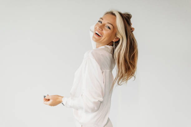 Hairstyle Confidence A confident woman with dyed hair celebrates her individuality and self-love. blond hair stock pictures, royalty-free photos & images