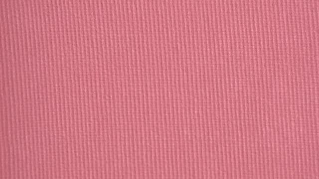 Pink cosmetics background. Pink blusher texture, macro, top view. Decorative cosmetics concept