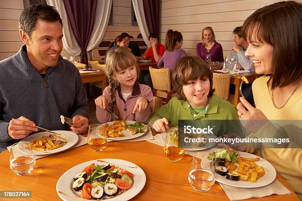 Family Eating Lunch Together In Restaurant Stock Photo - Download Image Now - Restaurant, Child, Crowded