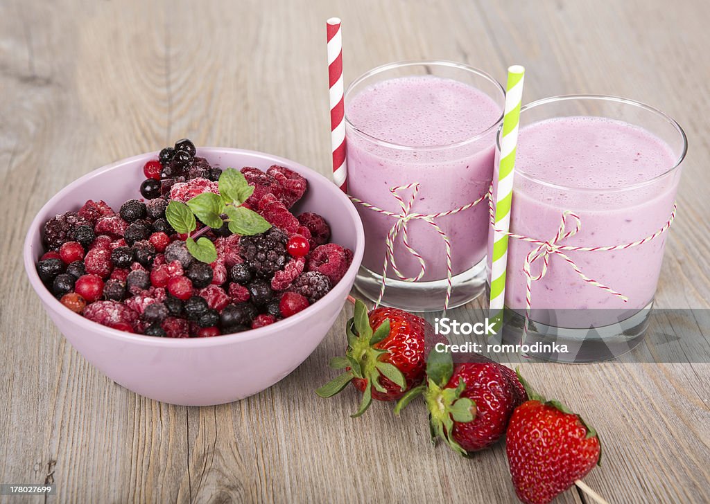 Strawberry healthy smoothie Strawberry and wild berry healthy smoothie drink. On wooden background. Berry Fruit Stock Photo