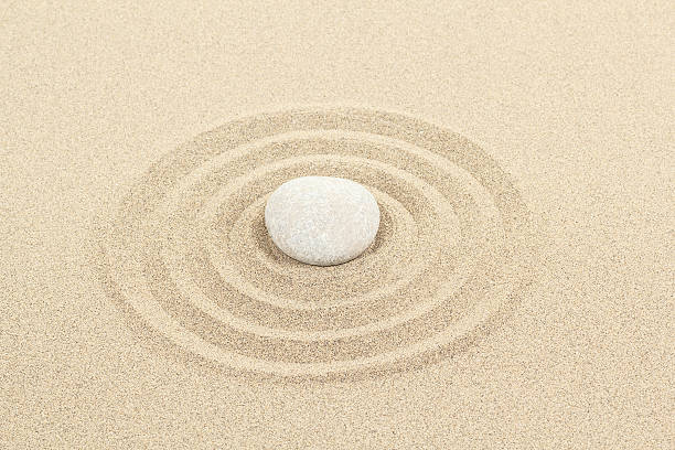 istock zen stone in sand with circles 178027891
