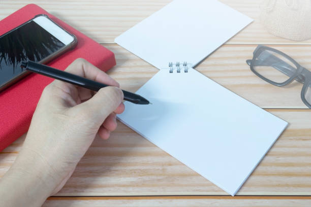 istock Hand with pen writing on the black clipboard. Copy space. 1780281463