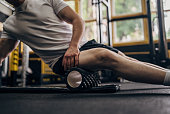 Man massaging his muscles with foam roller