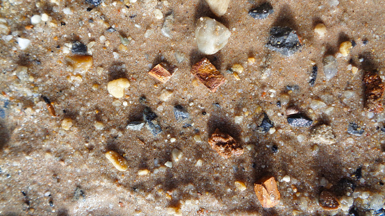 stone and wet sand beach in thailand