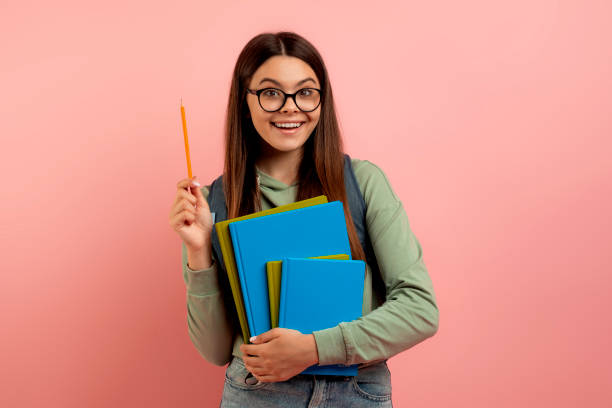 istock Joyful teen student with backpack and workbooks has a bright idea 1780285377