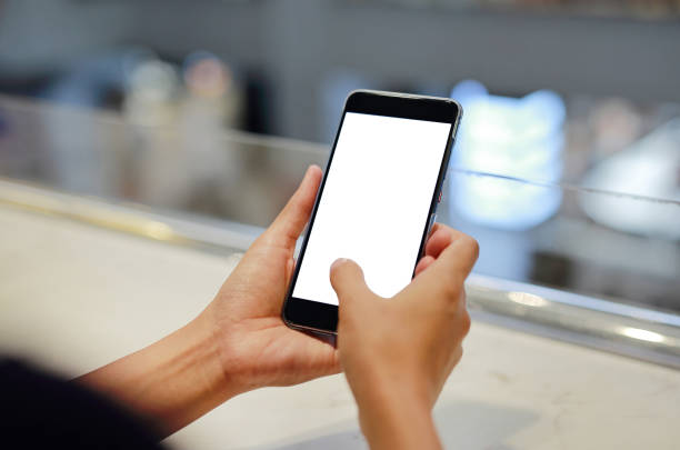 istock woman holding and using smartphone with blank white screen in cafe. 1780285397