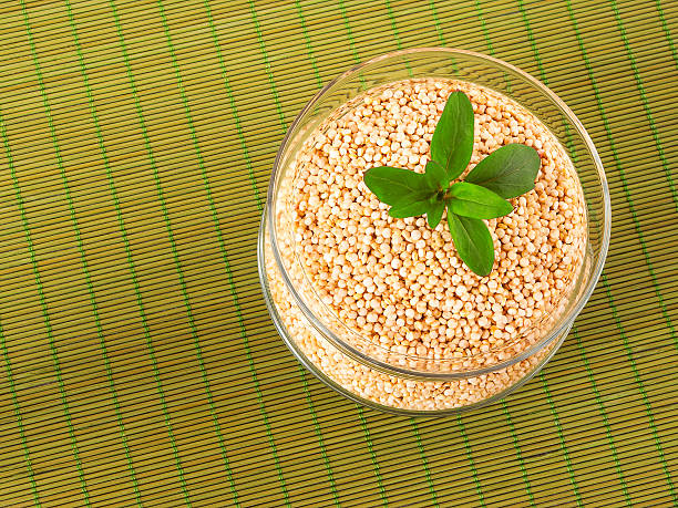 Quinoa in a glass pot on green napkin stock photo