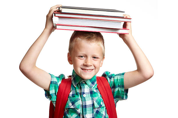 istock School boy with books on his head 178029578