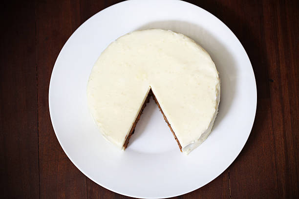 Cake with cream cheese icing, cut and piece missing stock photo