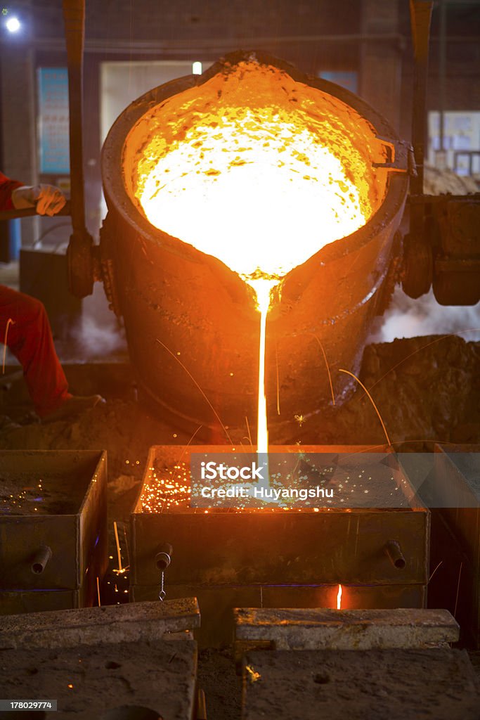 Molten lava being poured on metal Splashing of iron water Steel Mill Stock Photo