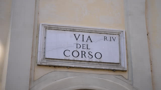 Close-up of Via del Corso street sign on main street of Rome on facade of building, famous for shopping. Concept of vacations and travel in Europe.