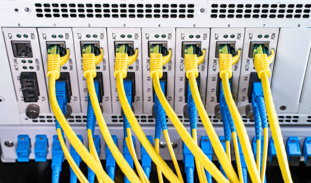 istock Fiber Optical cables connected to an optic ports and Network cables connected to ethernet ports 1780299083