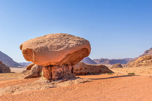 Wadi Rum, Jordan: Wadi Rum, also known as the Valley of the Moon, is a valley in southern Jordan, near the Saudi Arabian-Jordan border and about 60 km (37 mi) to the east of the city of Aqaba. With an area of 720 km2 (280 sq mi) it is the largest wadi in Jordan. Several prehistoric civilizations left petroglyphs, rock inscriptions and ruins in Wadi Rum. Today it is among one of Jordan's most popular tourist attractions. The Wadi Rum Protected Area has been a UNESCO World Heritage site since 2011.