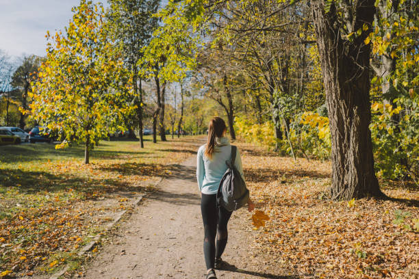 istock A girl in warm clothes walks through an autumn forest 1780310681