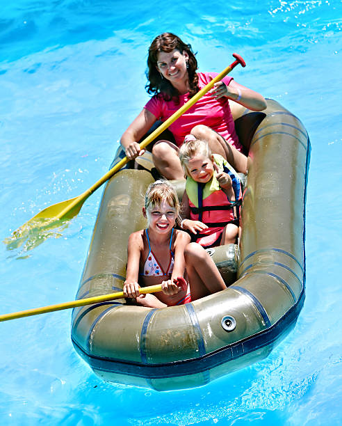 Family with children  ride  rubber boat at  swimming pool .