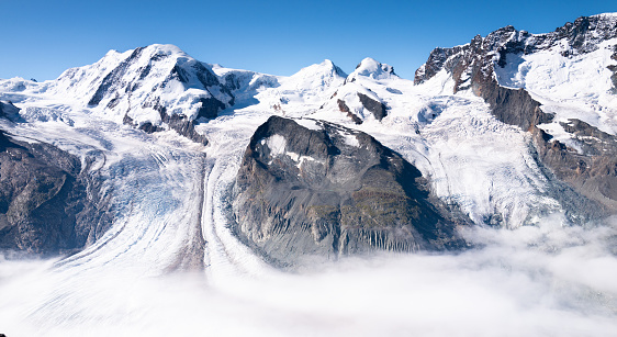 The Grenzgletscher above the clouds of the Swiss Alps from Gornergrat, Switzerland.