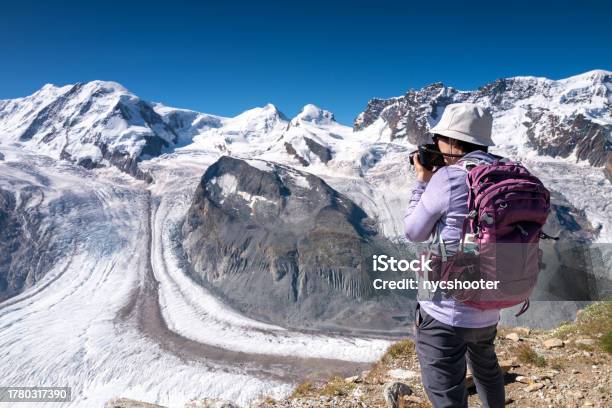 Switzerland Travel Female Hiker Photographing The View Of The Grenz Glacier Stock Photo - Download Image Now