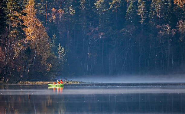 istock Rowboat with people on wild lake 178031788