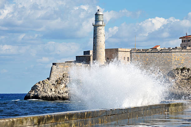 Harbour entrance, Havana, Cuba Waves crash onto the breakwater at the harbour entrance of Havana port, Cuba havana harbor photos stock pictures, royalty-free photos & images