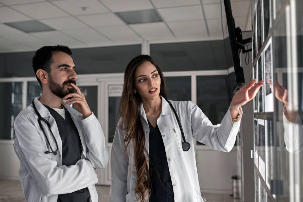 istock A group of surgeon interns is studying fetal development at different stages of pregnancy. Health education concept. Medical students in the classroom with images of ultrasound 1780323054