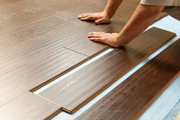 istock Man Installing New Laminate Wood Flooring 178032878