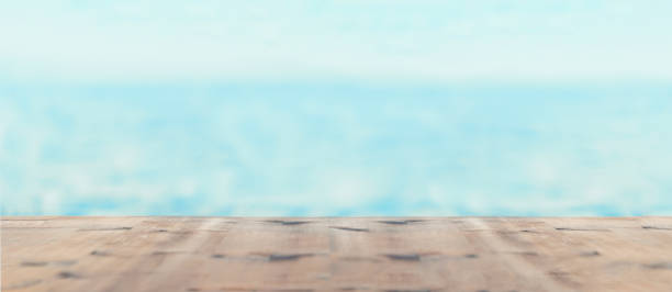 istock Blurred sea background with wood resort deck floor foreground. Photo with copy space. 1780334325