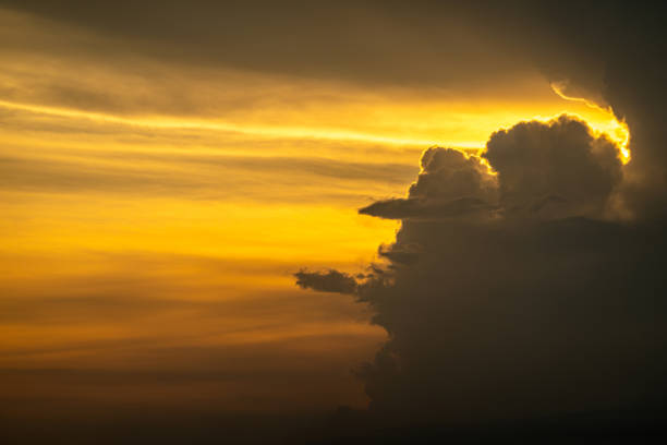Guatemala, Puerto Quetzal - July 20, 2023: Evening cloudscape. Sun lances fire beams from behind dark clouds