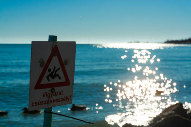 Warning sign at the beach of Balatonalmadi in a sunny winter day