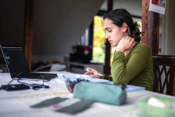 istock young woman studying at table with laptop 1780335312