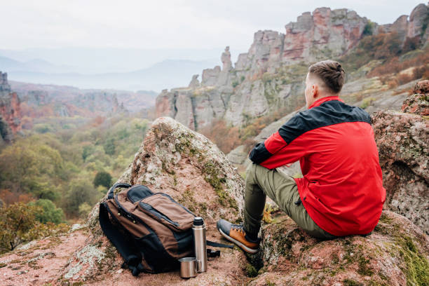 Young hiker admiring the view on top of the mountain