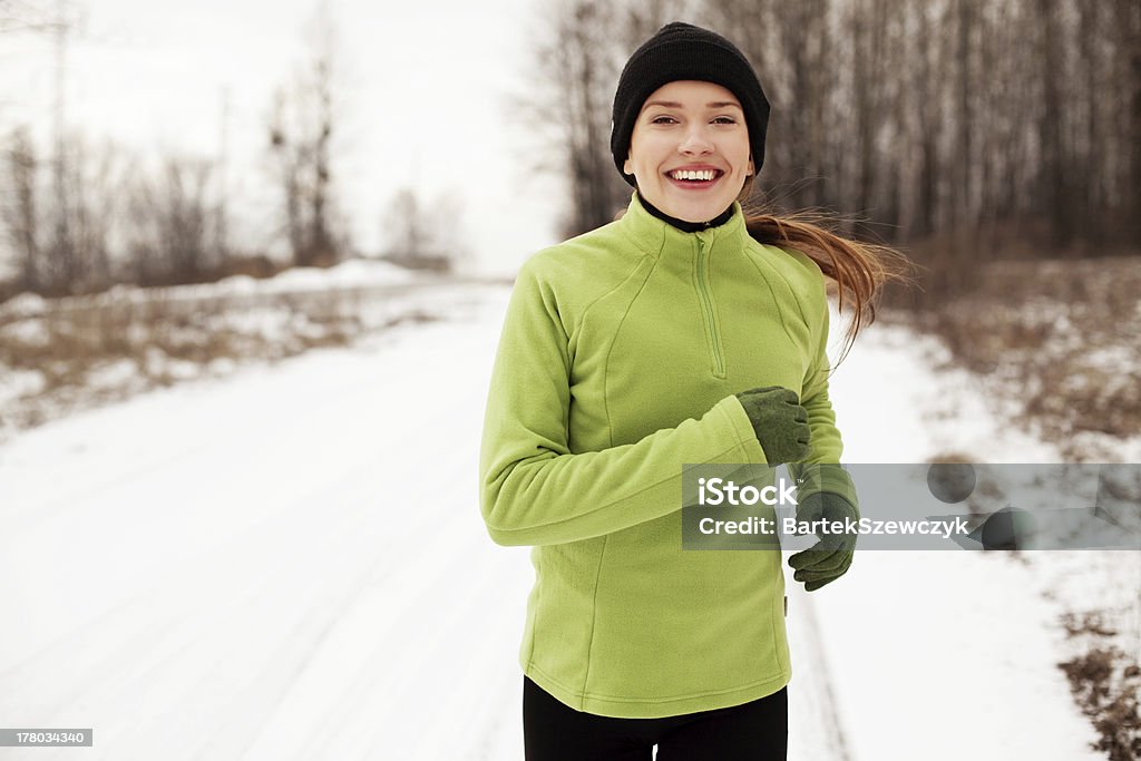 Woman running in winter Happy woman running in winter Jogging Stock Photo