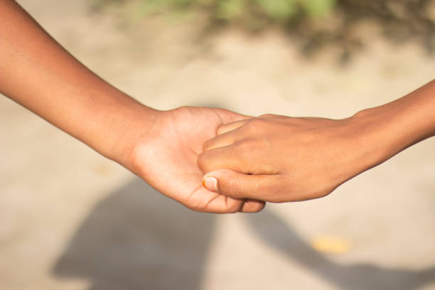 istock A man is holding the fingers of another man's hand down and blurred background 1780355749