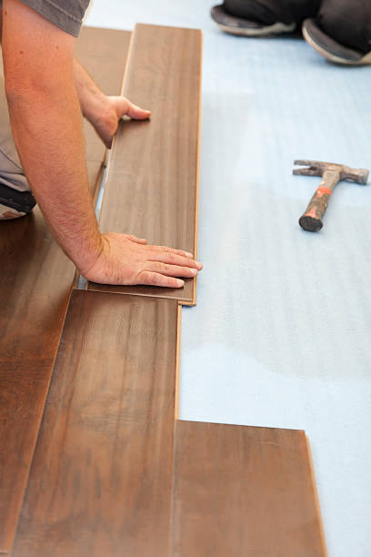 istock Man Installing New Laminate Wood Flooring 178035635
