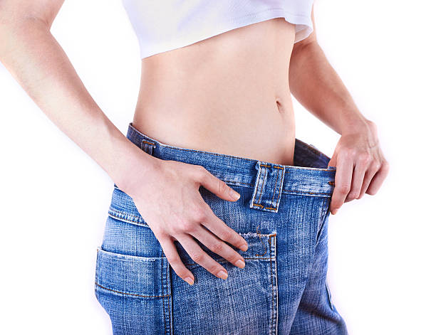 istock young slim woman in oversized blue jeans 178035679