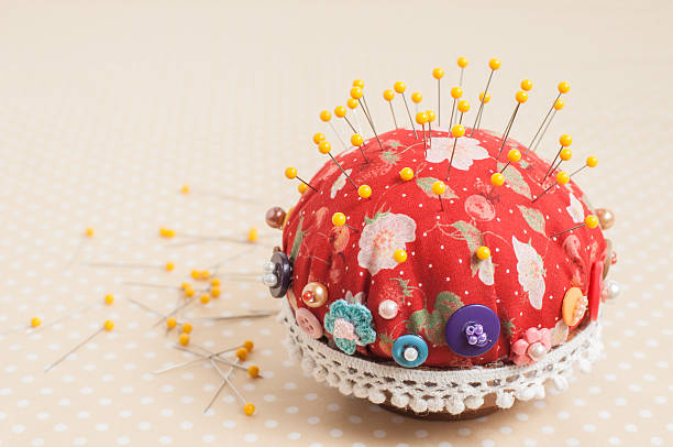 Yellow pinheads in vintage pin-cushion. stock photo