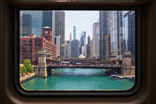 View through train window of city skyline. Chicago River and skyscrapers in downtown disctrict. Illinois, United States.