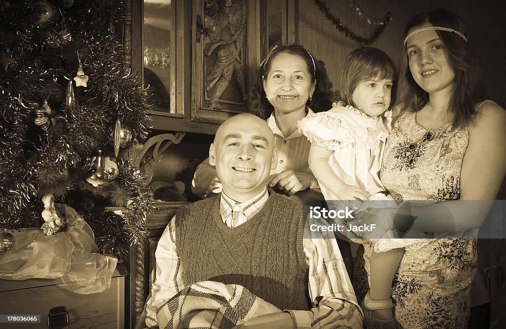Retro photo of happy  family Retro photo of happy  family of three generations posing for  Christmas portrait at home Old-fashioned Stock Photo