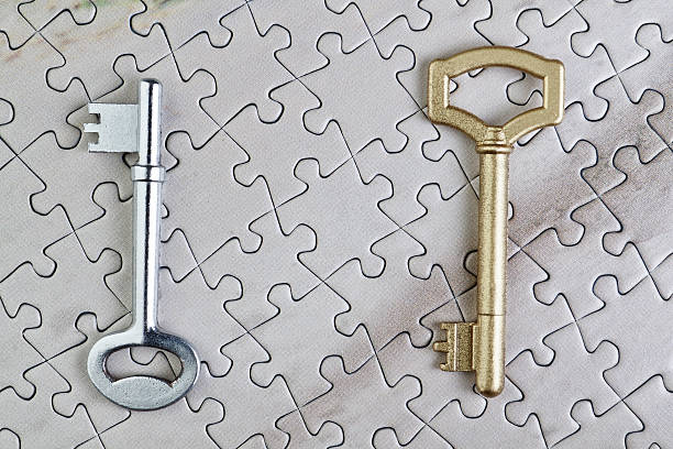 istock Keys to puzzles closeup gold and silver. 178036994