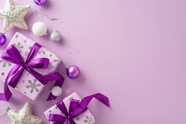istock Celebrate with this present-themed image concept. Overhead shot of stunning lilac gift boxes, celebratory baubles, glistening stars, sequins against purple background, perfect for personalized message 1780388839