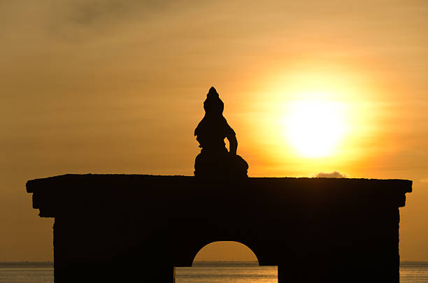 istock Silhouette of sitting Buddha against rising sun 178039048