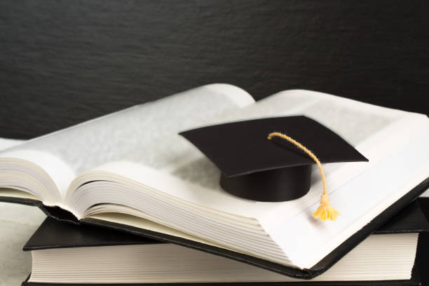 istock Open book on wooden deck table and black board background. Back to School. Education concept with copy space for your ad text. 1780410441