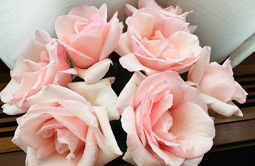 Red roses and baby’s breath with a “Loving Dad” ribbon at a funeral wake