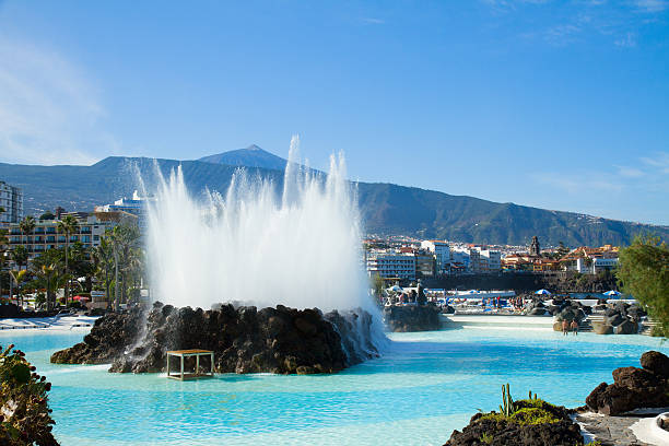 skyline of Puerto Cruz, Tenerife, Spain skyline of Puerto de la Cruz with Teide volcano and pool  fountain, Tenerife, Spain puerto de la cruz tenerife stock pictures, royalty-free photos & images