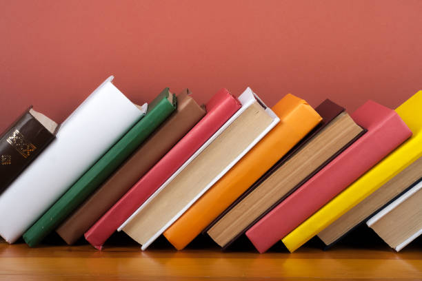 Open book, hardback colorful books on wooden table. Back to school. Copy space for text. Education business concept