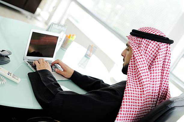 istock Portrait of an Arab at a desk using a small netbook 178043107
