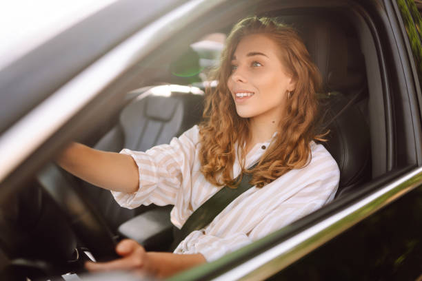 istock Smiling woman driving her car. 1780432630