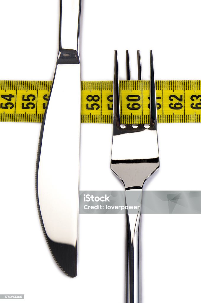 Diet and nutrition Fork and knife with measuring tape Concepts Stock Photo