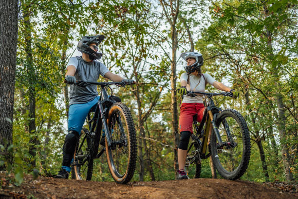 istock Couple riding mountain bikes in the forest 1780433861